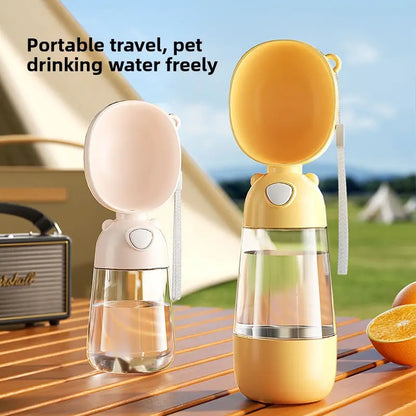 Two portable pet water bottles on a wooden surface with outdoor scenery in the background.