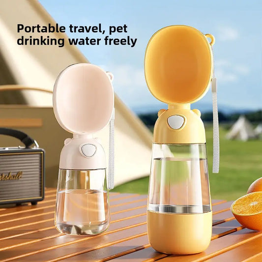 Two portable pet water bottles on a wooden surface with outdoor scenery in the background.